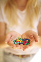 Woman holding confetti in her hands. Colorful confetti and sparkles used in a creative portrait session.