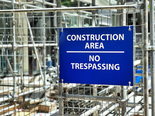 Selective focus of blue construction area no trespassing sign.