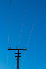 Top of a three-phase transmission line pole with insulators.