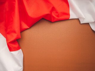 Top view of the Japan flag on a brown background with space for text