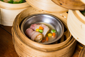 variety of dim sum in bamboo steam containers