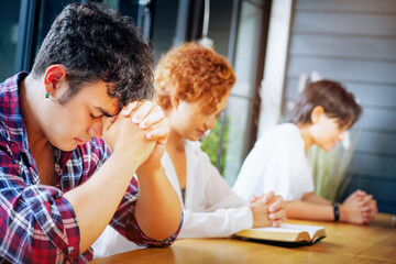 Christian Praying on open Bible.