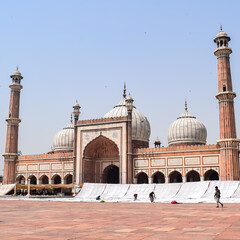 Fototapeta na wymiar Delhi, India - April 15, 2022 : Unidentified Indian tourists visiting Jama Masjid during Ramzan season, in Delhi 6, India. Jama Masjid is the largest and perhaps the most magnificent mosque in India
