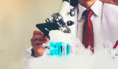 Scientist pouring colorful liquid into sample compartment in laboratory