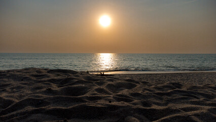 Obraz premium Sunbed with background of sandy beach and clear sky with nobody and copy space in Phuket area, Thailand