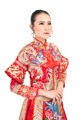 Fototapeta premium Portrait of a young asian Chinese female lady model wearing red traditional vintage wedding costume smiling and posing with different poses and gestures 