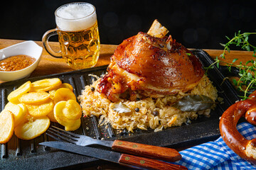 rustic pork knuckle with sauerkraut, sweet mustard and fried potatoes