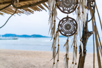 Dream catcher hanging on a tree seaside - 510740473