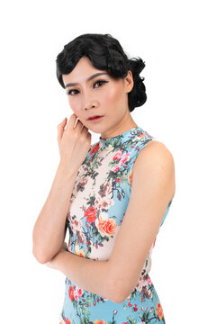 Portrait of a young asian Chinese female lady model wearing a patterned traditional vintage costume Cheongsam smiling and posing with different poses and gestures 