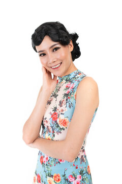 Portrait of a young asian Chinese female lady model wearing a patterned traditional vintage costume Cheongsam smiling and posing with different poses and gestures 