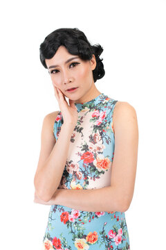 Portrait of a young asian Chinese female lady model wearing a patterned traditional vintage costume Cheongsam smiling and posing with different poses and gestures 