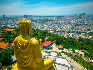 Ariel view Golden Buddha statue's hand holding lotus at Chon Khong Monastery which attracts...