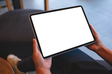 Mockup image of a woman holding digital tablet with blank white desktop screen