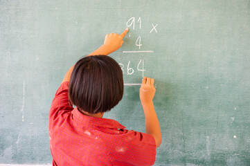 Students doing math exercises on the blackboard
