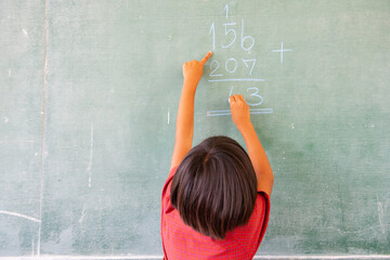 Students doing math exercises on the blackboard