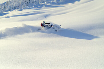 Snowmachine rider in Alaska backcountry