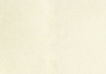 Fototapeta premium Large image close up paper texture background with aged uncoated fine fiber grain and dust particles sketch water color paper in light beige yellowed color copy space for text wallpapers or designs