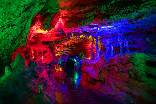 Horizontal background image of the dark blue, purple, green lighting of the Huanglong cave, Zhangjiajie, Hunan, China, copy space for text, background