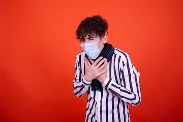 Illness and cold. Handsome guy and orange background.