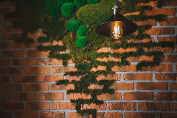 Retro vintage incandescent lamp in a stylish loft interior against the background of a brick wall...