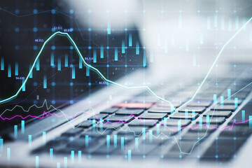 Close up of laptop with abstract glowing forex graph on blurry background with candlestick. Invest,...