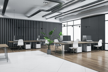 Perspective view on spacious coworking office with light concrete and wooden floor, brown tables with modern computers surrounded by white chairs, green plant in flowerpot and big window. 3D rendering