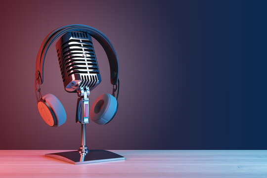 Podcasting and radio concept with retro microphone and headphones on empty wooden table and dark blank wall background with place for your logo or text. 3D rendering, mock up