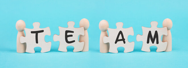 The word team is standing on puzzle pieces, connect the parts together, corporate in teamwork, communication and support concept