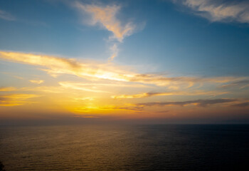Naklejka na ściany i meble A sea sunset with cloudy sky.