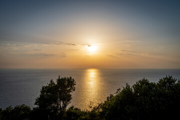 Fototapeta na wymiar A beautiful sea sunset with the sun casting light reflection on the sea. Lefkada island, Greece