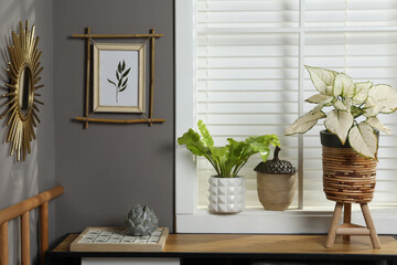 Stylish room interior with bamboo frame on grey wall