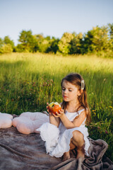 little girl with apples in park