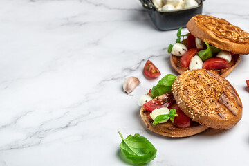 Healthy Grilled Basil Mozzarella Caprese Panini Sandwich on a light background. Delicious breakfast or snack, Clean eating, dieting, vegan food concept. top view