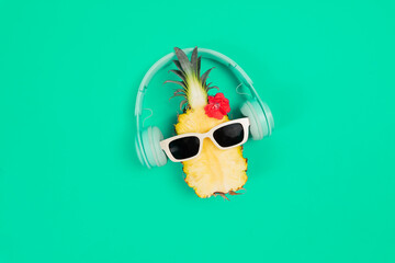 pineapple in a sunglasses and headphone on white background