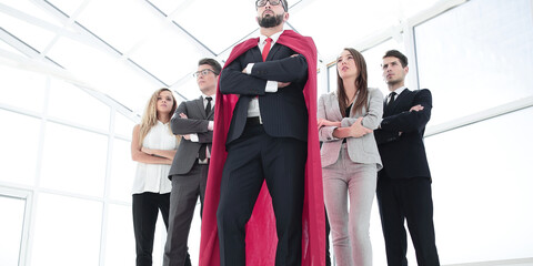 leader in the red cloak and the business team standing together