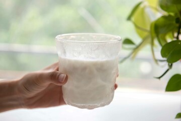 Pure milk in glass, naturally healthy foods placed on a white wooden table