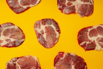 Flat lay with with jamon on orange background