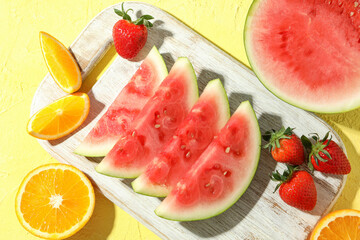 Fresh and juicy fruits on yellow textured background