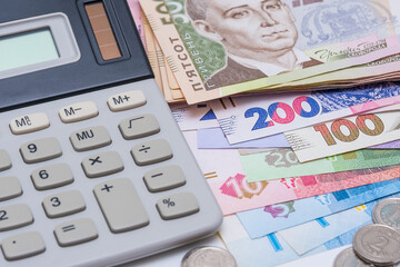 Ukrainian hryvnia and coins, background. Concept of receiving a salary, pension, inflation, deposit and credit. Concept of increasing the price of utilities, energy, gast