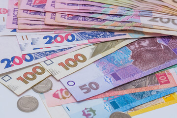 Ukrainian hryvnia and coins, background. Concept of receiving a salary, pension, inflation, deposit and credit. Concept of increasing the price of utilities, energy, gast