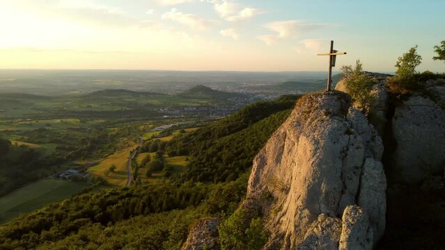 Aerial footage of circling around cliff ledge with beautiful mountain panorama in the Swabian Alps in Southern Germany at sunset