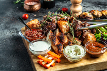 delicious grilled meat with vegetable. Mixed grilled bbq meat with vegetables on wooden platter....