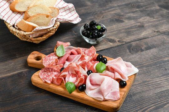 Food antipasti prosciutto ham, parma ham, salami, olives and  bread. Charcuterie plate.