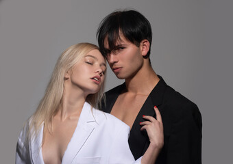 Sexy young couple in love. Sensual portrait of young couple in love. Loving couple embracing and kissing. Couple in love on date in formal fashion look.
