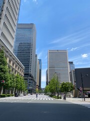Street pedestrian’s crossings at the Tokyo Station square, city high buildings and the...
