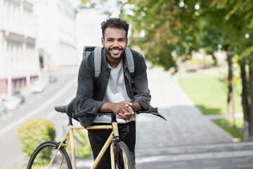 Handsome young man with bicycle in city, Smiling student men outdoor portrait, Active lifestyle,...