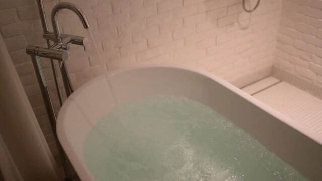 slow motion scene, water flowing in bathtub