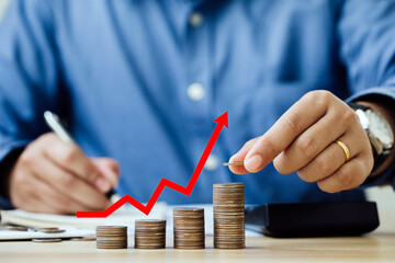 inflation economic concept. Businessman placing coins on stacked coins in increasing order with a...