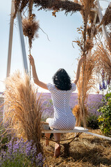 Blonde woman posing with decorations situated  in lavender field