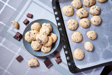 Chocolate chip cookies on baking tray at domestic kitchen